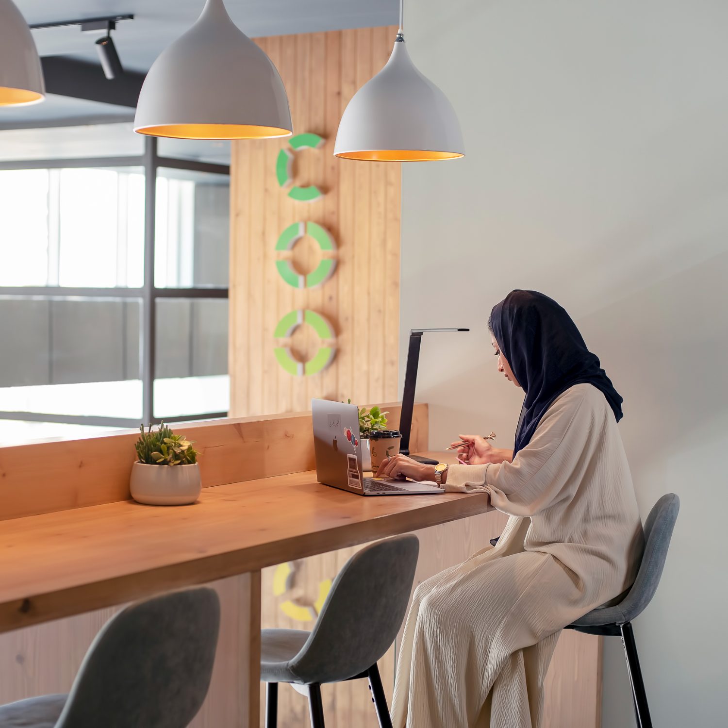 A member focused at her workspace